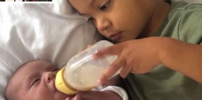 Remi Leigh Henriques’s brother feeding her milk.
